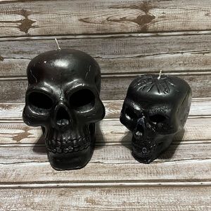 Set of two black skull candles.